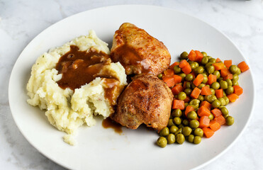 chicken thighs  with mash potatoes gravy and vegetables