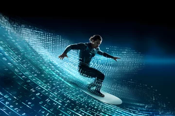 Foto auf Acrylglas Fearless man surfing on a big blue wave of digital data, looking expert & in control. © Giotto