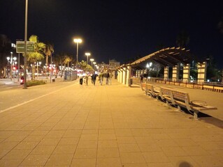 Obraz premium illuminated street near Barcelona beach at night in Spain
