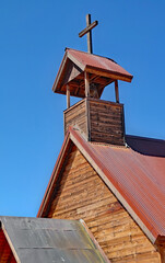 Old west church cupola bell tower topped with a wooden cross