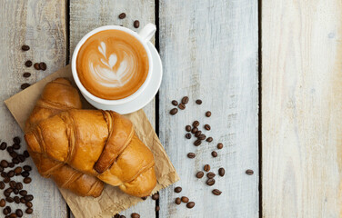 White coffee cup, croissants on wood table background. Flat lay. Top view. sweet baking dessert for...