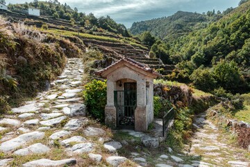 Small stone house design on the side of a rocky path in Sistelo, Portugal