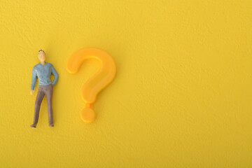 The question mark symbol isolated on a yellow background acts as a beacon, inviting people to make...
