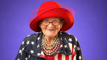Portrait of smiling, happy, funny crazy grandmother mature woman, 80s, wearing patriotic flag jacket isolated on purple background. Concept of youthful old female.