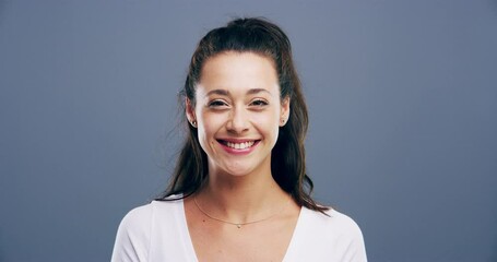 Woman, face and wink in studio with smile for flirting expression, secret and romance on gray background. Young person, portrait or winking for confidence, happiness and joyful emoji on mock up space - Powered by Adobe