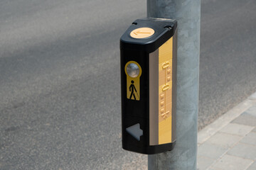 button, positioned at crosswalks.  tactile button, mounted on a pole, serves as an essential tool...