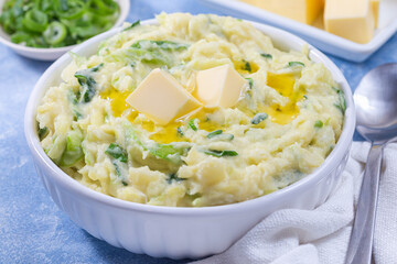 Traditional Irish dish Colcannon or mashed potato with green cabbage and butter, horizontal