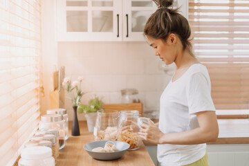 Obraz na płótnie Canvas Asian woman preparing breakfast in the kitchen in the morning.