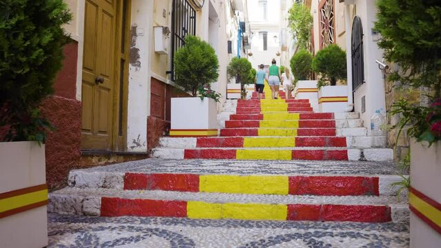 Family Walking Up Stairs Painted In Spain Colours In Calp Old Town
