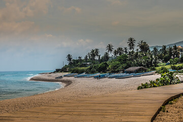 Boats sitting on the arena near the beach.