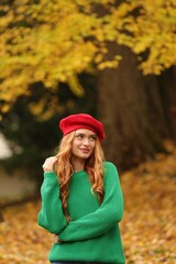 Portrait of beautiful woman in autumn park