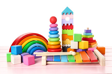 Different children's toys on pink wooden table against white background