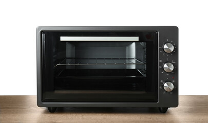 One electric oven on wooden table against white background