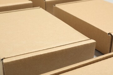 Many cardboard boxes on white background, closeup. Packaging goods