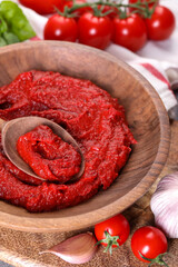 Tasty tomato paste and ingredients on table