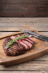Delicious fried beef meat served on wooden table