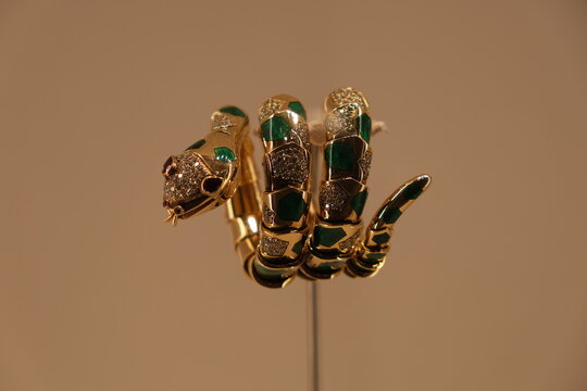 Shanghai,China-April 8th 2023: Bulgari Serpenti bracelet watch in gold with green enamel, rubies and diamonds