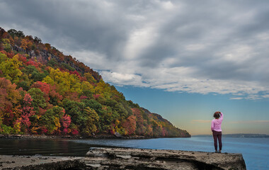 A lady in pink is enjoying the amazing Autumn view Of Hudson River in  the Palisades Interstate Park in New Jersey © Jay