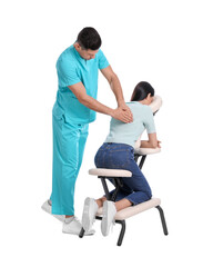 Woman receiving massage in modern chair on white background