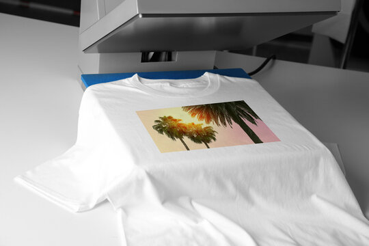 Custom t-shirt. Using heat press to print image of beautiful tropical palm trees, closeup