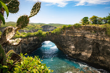 The spectacular phenomenon of a natural bridge between the bay and the ocean at Broken beach on the island of Nusa Penida near Bali, Indonesia - obrazy, fototapety, plakaty