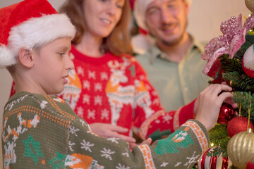 Happy Caucasian - Western family enjoy decorating a Christmas tree.