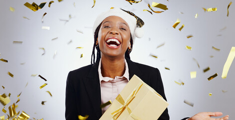 Portrait, confetti and business with black woman, present and celebration on a white studio...