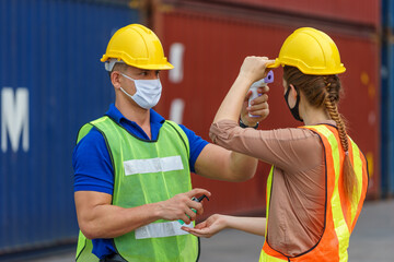 The foreman is measuring the temperature. Caucasian woman clothing. In the container storage yard