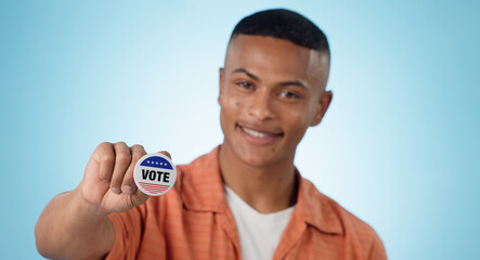 Man, vote sticker and smile for election, positive and politics for america, government and blue studio background. Badge, voter choice and support for party, registration or hand for voting register - obrazy, fototapety, plakaty