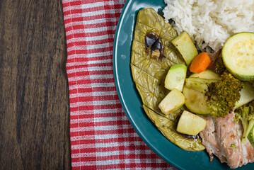 Fish fillets, vegetables and cactus (nopal) baked with white rice on a wooden table. Healthy food.
