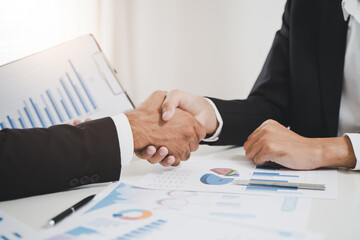 finance planning advisor and client investor shake hands agree signing contract deal after investing document reviewed.