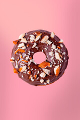 Chocolate donuts, on a pink background.