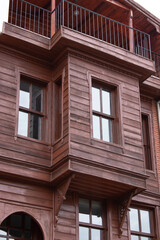 restored wooden house with grilled windows and balcony