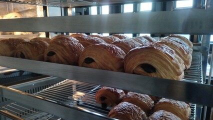 Pain Au Chocolat is freshly cooked and is on the cooling rack. Homemade sweet French food
