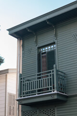 restored wooden house with grilled windows and balcony