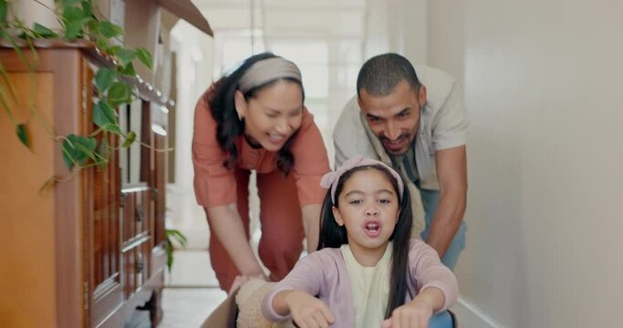 Family, new home and push in box, smile and together in house for driving game. Mother, father and kid play in cardboard, happy or excited for real estate, moving and celebrate mortgage in portrait