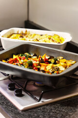 cooking at home healthy food, baked Mediterranean vegetables and dish of potatoes