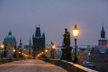 Winter twilight in Prague, snow, no one, lights on, Charles Bridge