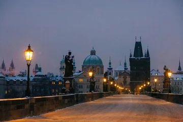 Fotobehang Winter twilight in Prague, snow, no one, lights on, Charles Bridge © Cavan