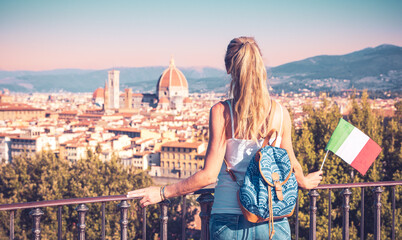 Rear view of female tourist with italian flag- Florence city landscape and Duomo- travel, tour...
