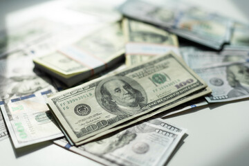 Different dollar bills and business graph in the background. Natural photo.