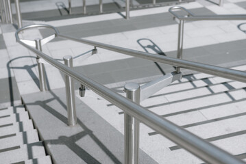 Beautiful stainless steel handrails are installed on the walls and steps at football stadium.