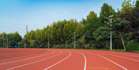 Fototapeta premium Athlete track or running track with green trees in the playground