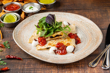 Mexican food molotes with sauces on wooden table