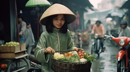 Selbstklebende Fototapeten vintage asian girl with scooter at market wearing pale green ao dai © JKLoma