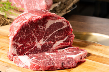 Close-up beef raw red steak on wooden board background.Meat texture.