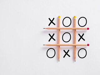 Tic tac toe strategy game with pencils used as lines.