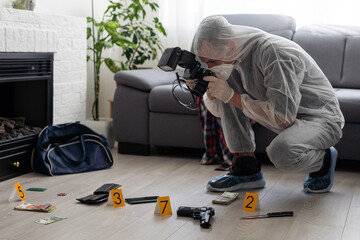 Forensics researcher photographing a blood at a murder scene - obrazy, fototapety, plakaty
