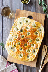 Focaccia with olives and rosemary. Italian food. Vegetarian food.