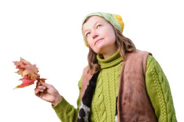 Portrait of a woman in a knitted hat and sweater with autumn leaves, isolated on white background. Portrait of a woman aged 52